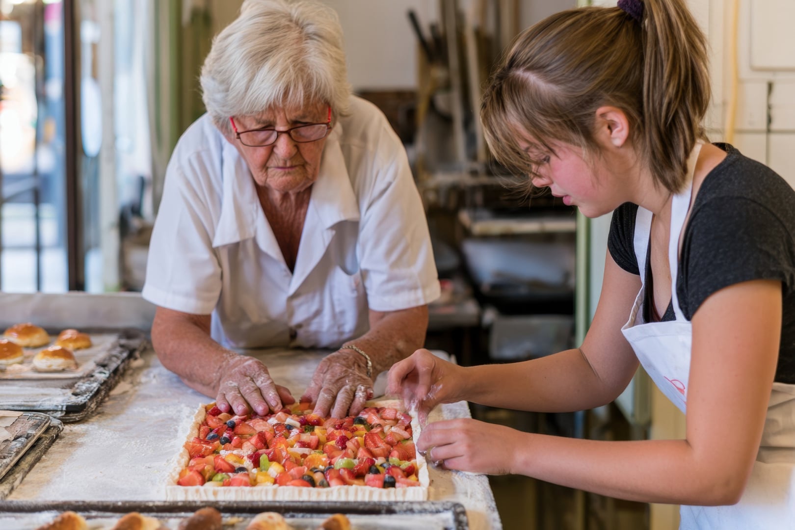 2 woman making  a pie in a bakery shop