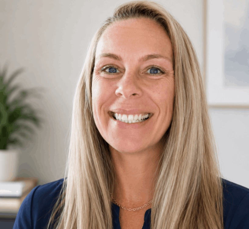Erica Blosser  in blue shirt and smiling in an office
